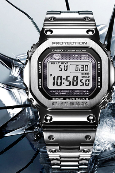 GSHOCK silver GMWB5000 digital metal watch and band on a gray glass background 